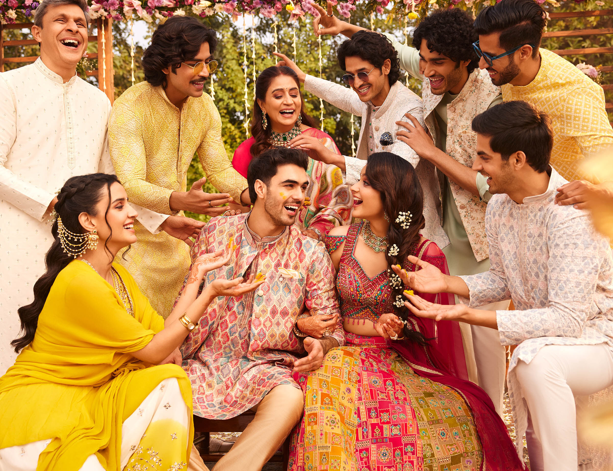 Friends striking joyful poses during a Haldi ceremony photoshoot at a wedding